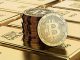 Picture of bitcoins sitting on top of a stack of gold bricks